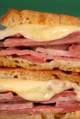 Closeup of corned beef sandwich with cheese on rye