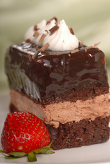 Chocolate mousse cake with whipped cream and strawberry