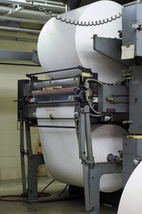 Two large paper rolls on a printing press