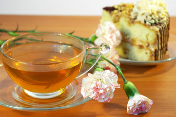 Cup of tea, flowers and cake