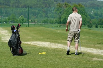 golfer on training and golf bag