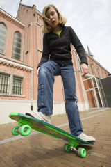 girl standing on her skate board