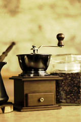 Fototapeta na wymiar Coffee - grinder with ibric on a table