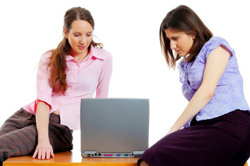 two young attractive women working with the computer
