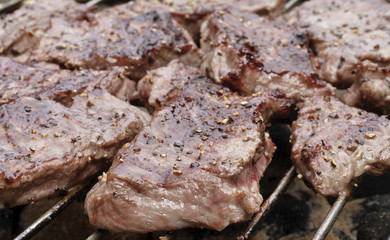 steaks on  barbecue grill