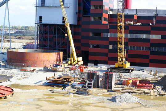 cranes and chinmey on construction of industrial factory