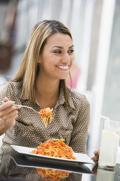 Woman Eating Pasta At Cafe