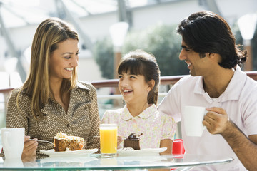 Family enjoying snack at cafe
