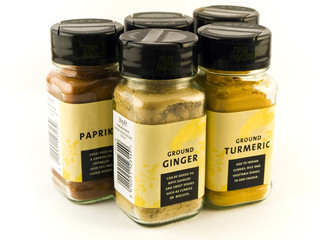 Jars of Eastern Spices on White Background