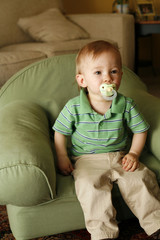 Boy watching cartoons from his chair