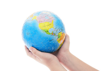 Hands holding globe jigsaw puzzle