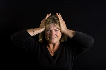 Shot of a Senior Lady with Hands on her Head