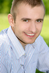 Fototapeta premium Smiling man on the green outdoors.