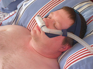 Man wearing CPAP nasal pillow facemask