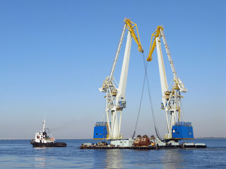 Fototapeta na wymiar Large maritime cranes and boat
