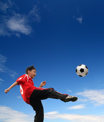 Fototapeta na wymiar asian boy playing football