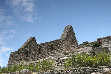 Fototapeta na wymiar Terraces and ruined house in lost Inka city of Machu Picchu