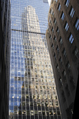 Skyscraper reflecting at glass facade - 7706646