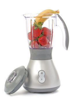 Blender with strawberries and one banana