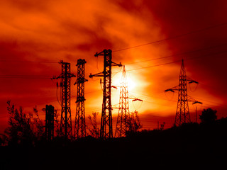 Naklejka premium electricity pylons at the sunset