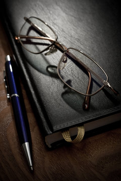 book pen and glasses