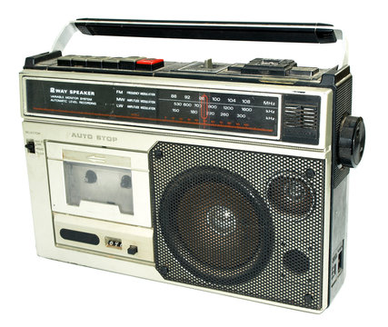 Dirty old 1980s style cassette player radio against a white back