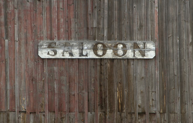 Old Saloon Sign on Weathered Wood Wall