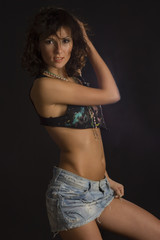 Fototapeta premium Smiling girl in mini skirt posing in studio