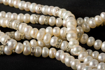 Pearl necklace on black background