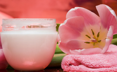 cream, towel with flowers on red background