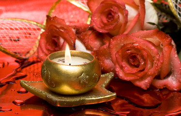 golden candle with red roses