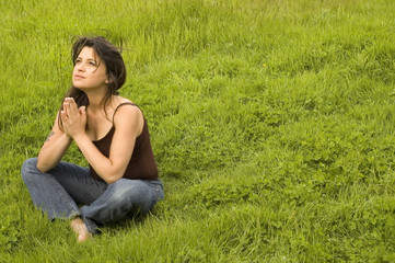 Young woman sitting in praying pose (more images in portfolio)