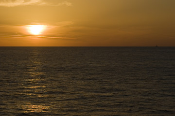 Distant oil rig in sunset light