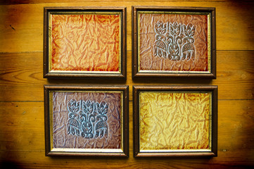  frames with leather texture on wooden wall