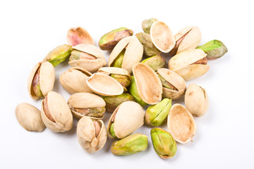 Several pistachio nuts naked and in shell close up isolated