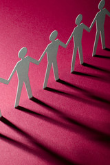 figures of man in paper on magenta
