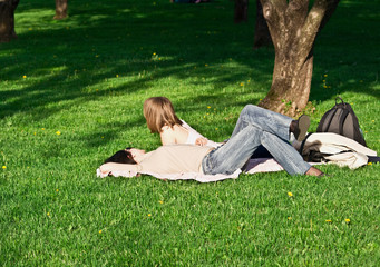 Girls relaxing on park grass