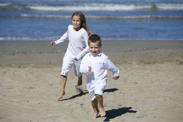 Happy children playing at the beach