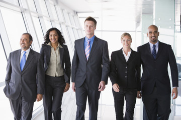 Group of business people walking towards camera