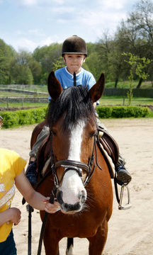 The Young Boy Rides On A Horse