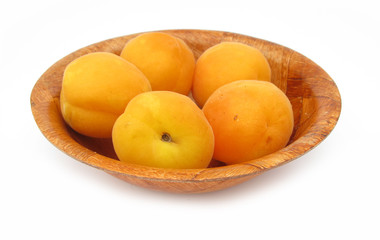 Naklejka na ściany i meble Apricots in wooden dish isolated on white background