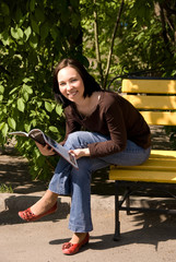 Fototapeta premium Young woman reading a magazine 