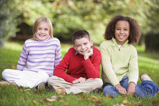 Group of children sitting in garden