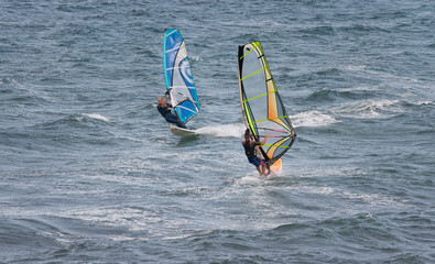 Windsurfers sufing on the sea of beach Pozo Izquierdo. Gran Cana