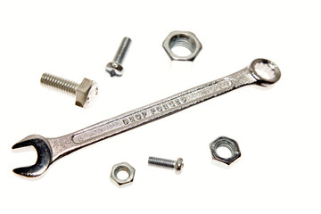 Spanner, nuts and bolts on white