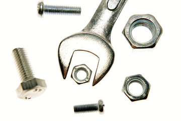 Spanner, nuts and bolts on white