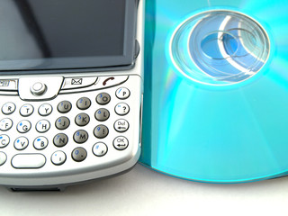 Fototapeta premium CDs DVDs and Mobile Phone PDA on White Background