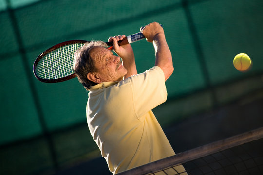 Senior man plays tennis