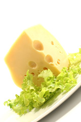 chunk of cheese and lettuce on dish