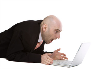 Amazed businessman using laptop